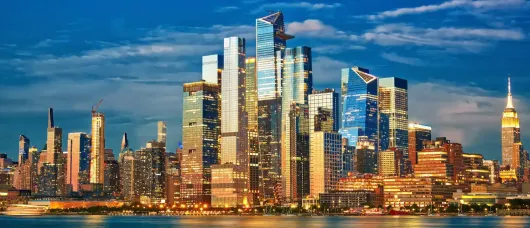 Midtown Manhattan and Hudson Yards skyscrapers at dusk in New York City, USA, showing illuminated skyline and modern high-rise buildings